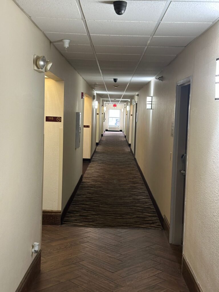 Hotel hallway at a Budget Hotel in Monee IL providing easy access to comfortable guest rooms